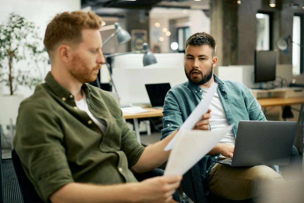 Two colleagues reviewing business documents together